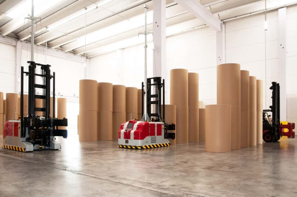 the inside of a warehouse with large tubes for paper