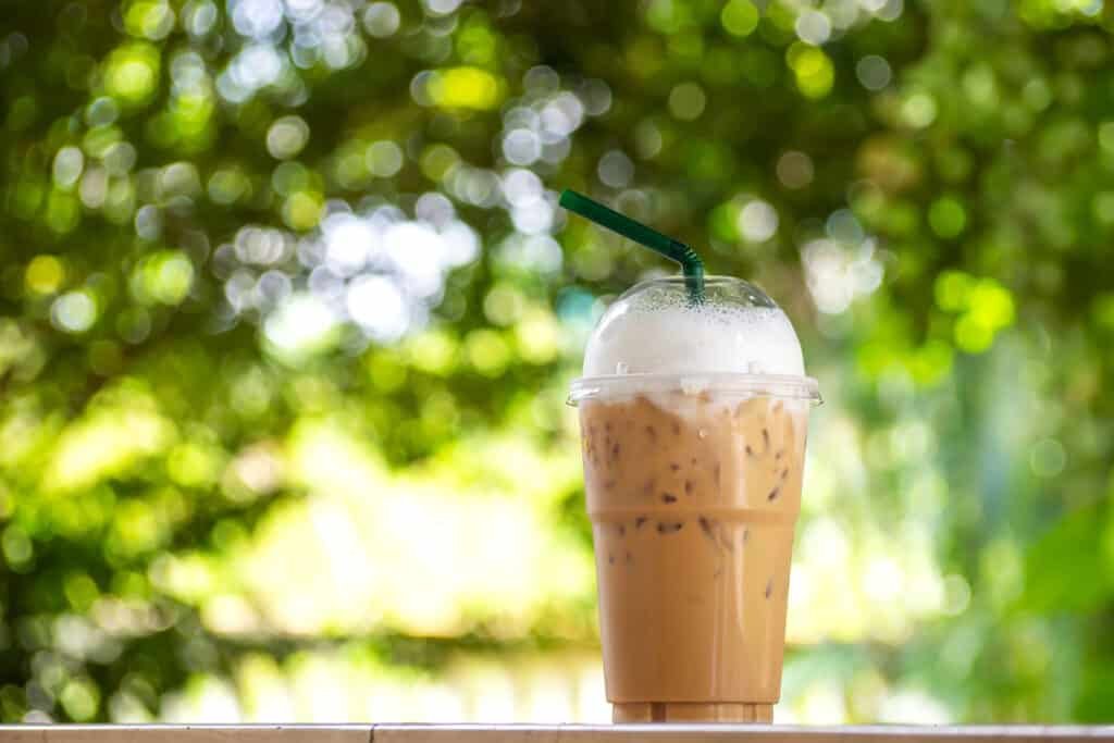 ice cappuccino with milk foam in plastic cup. take away package.